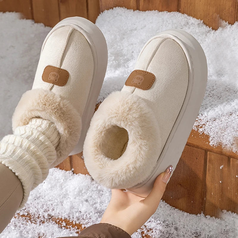 Hand holding Cream Faux Fur Slipper Booties