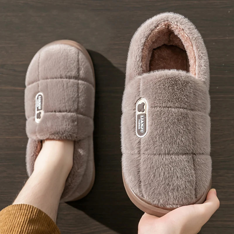 Hand holding a Mocha Quilted Plush Slipper showing the plush lining