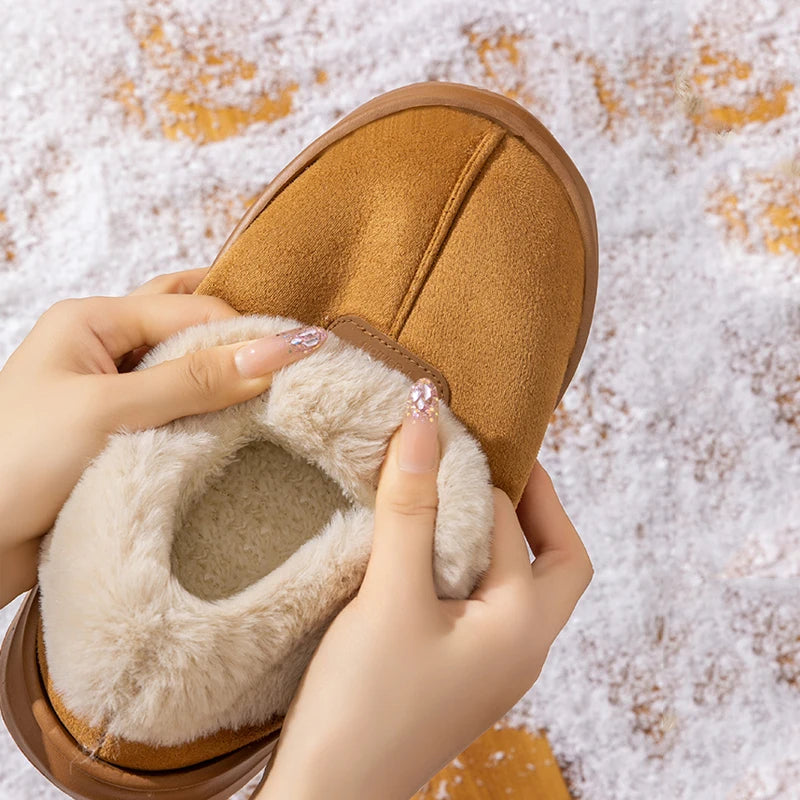 Hands opening a Faux Fur Slipper Bootie to show the plush lining